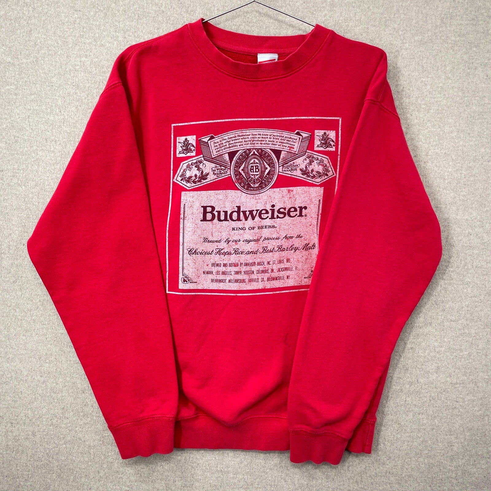 Red sweatshirt with Budweiser logo on a gray background