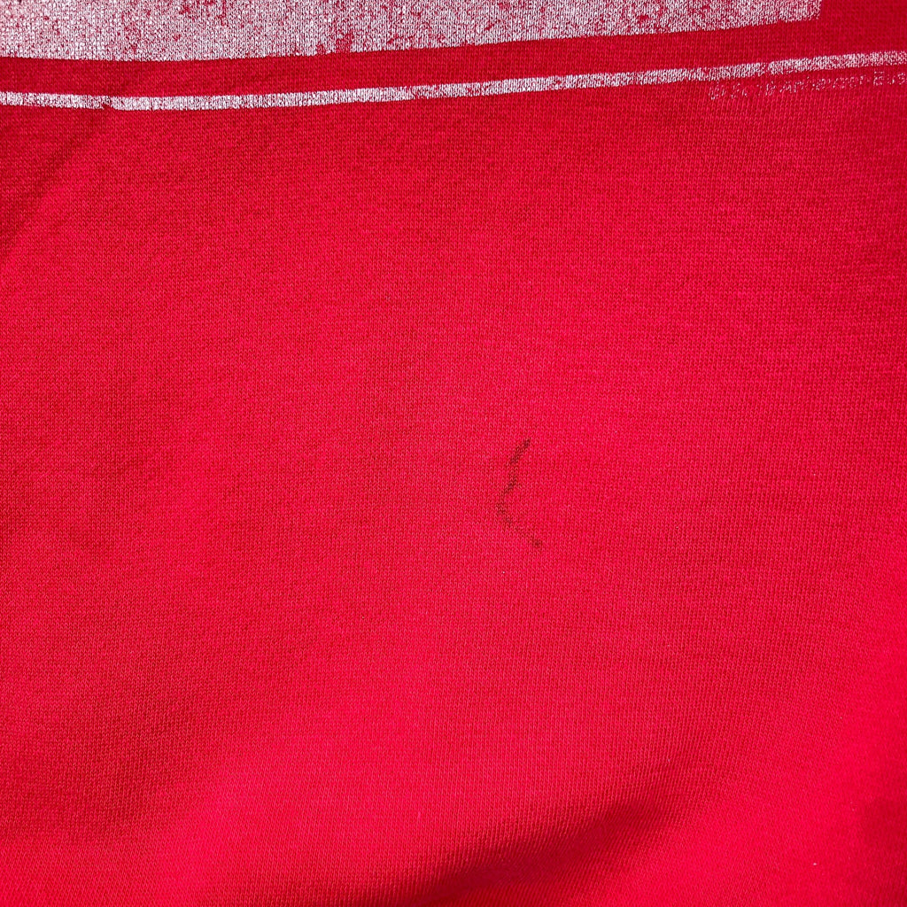 Close-up of red fabric with a small dark spot