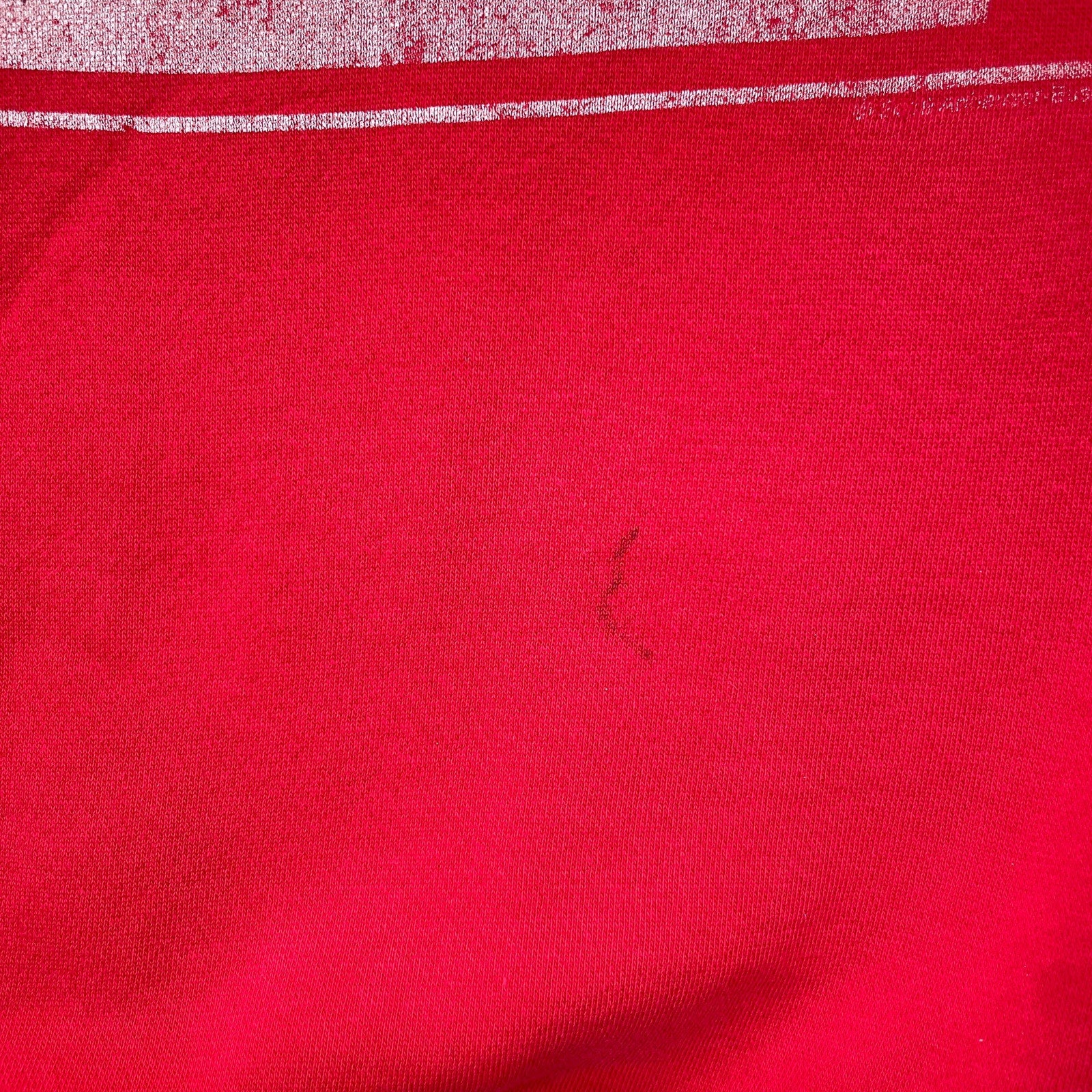 Close-up of red fabric with a small dark spot