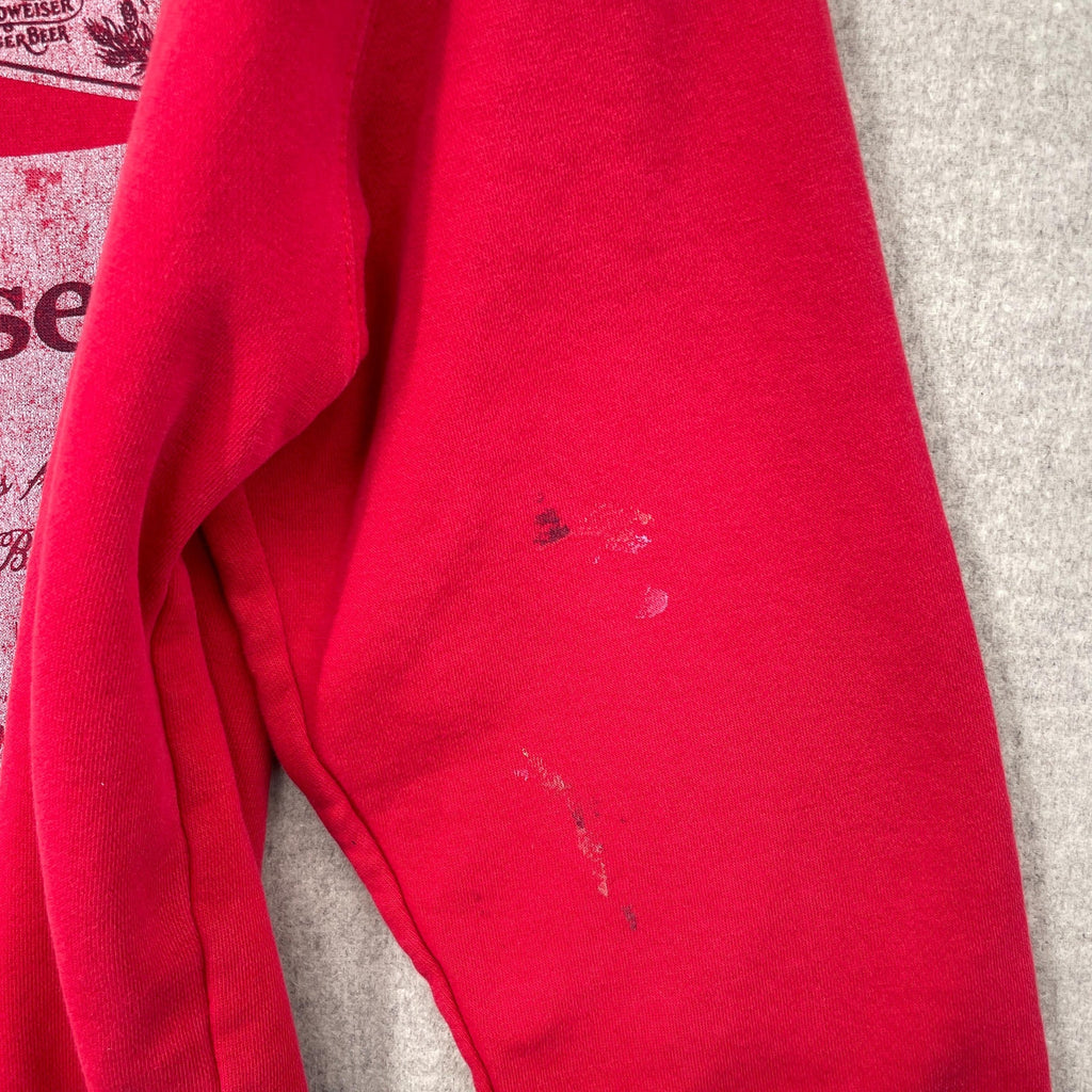 Red fabric with visible stains on a gray surface