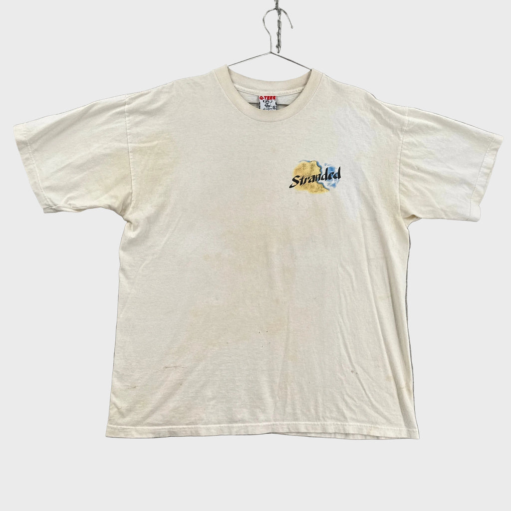white shirt with yellow discolouration and small chest logo that says stranded