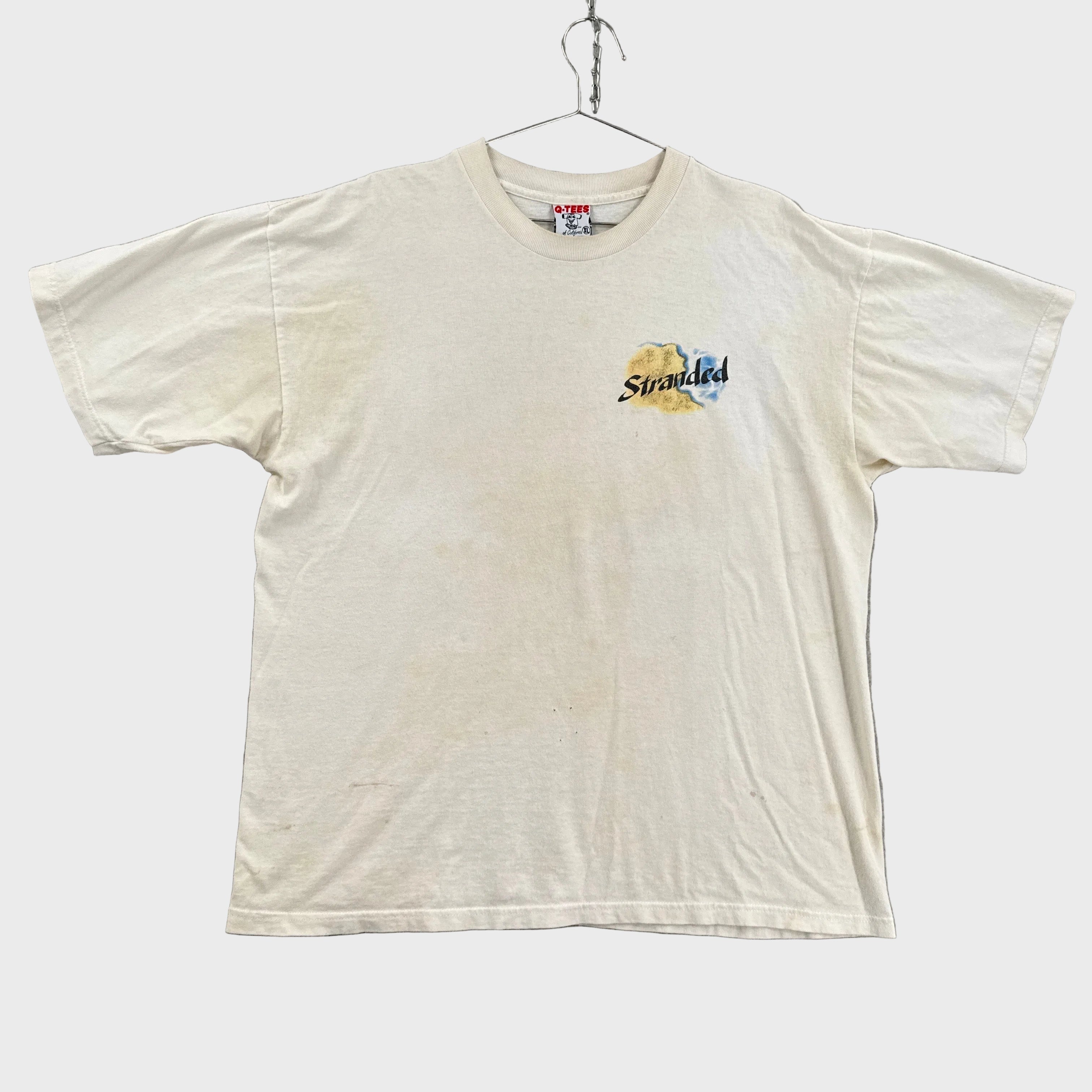 white shirt with yellow discolouration and small chest logo that says stranded