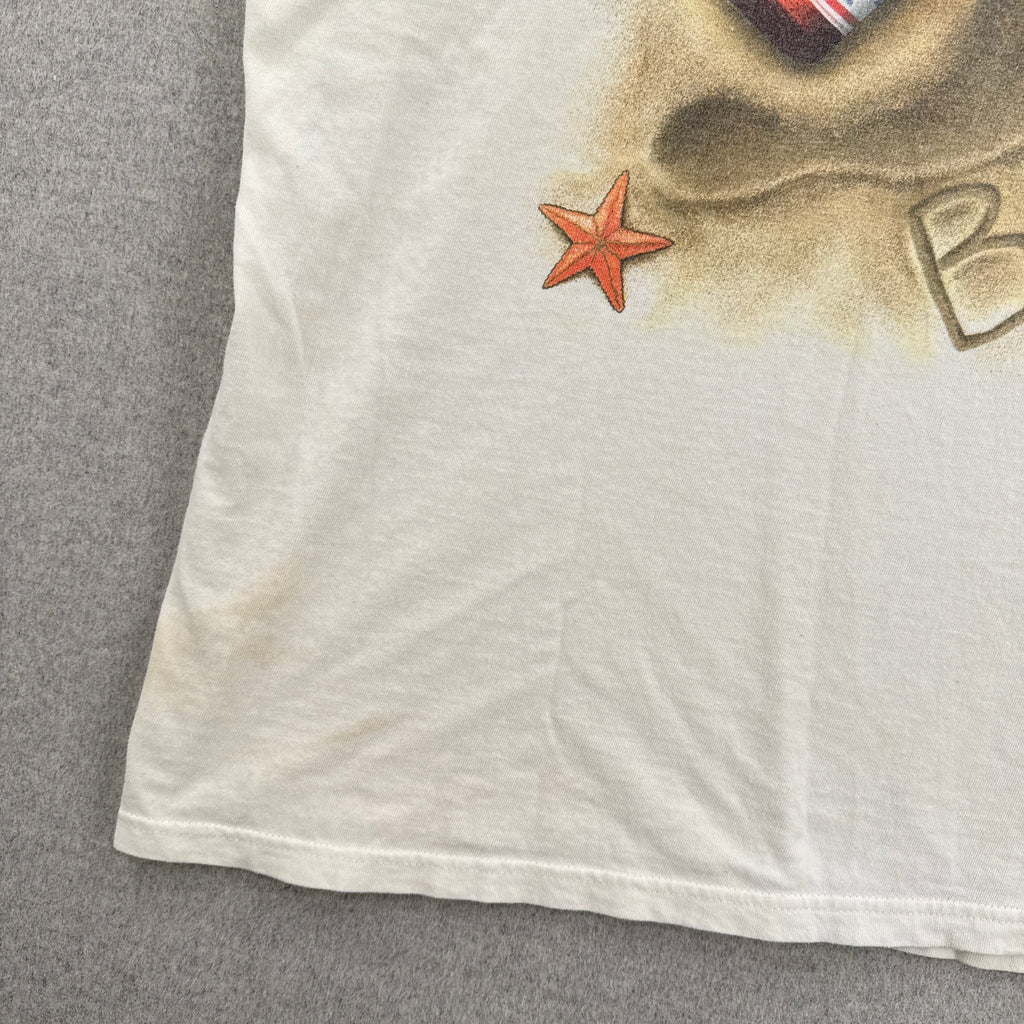 White fabric with a starfish design on a gray surface, stain spots