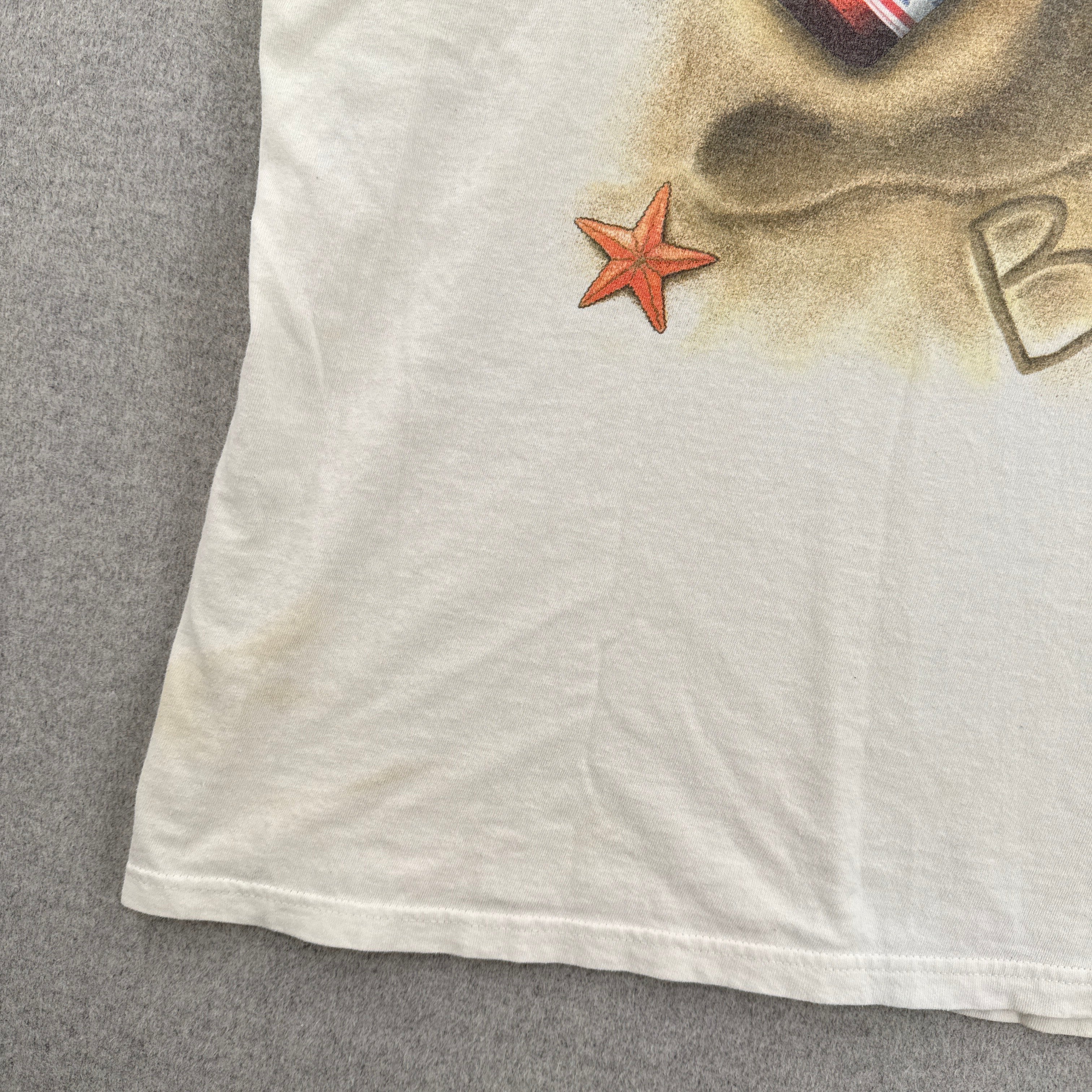White fabric with a starfish design on a gray surface, stain spots