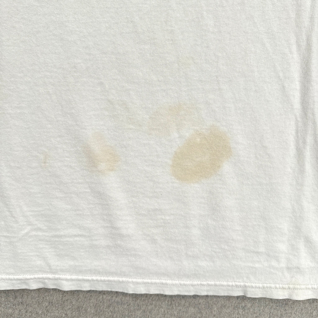 White fabric with brown stains on a gray surface
