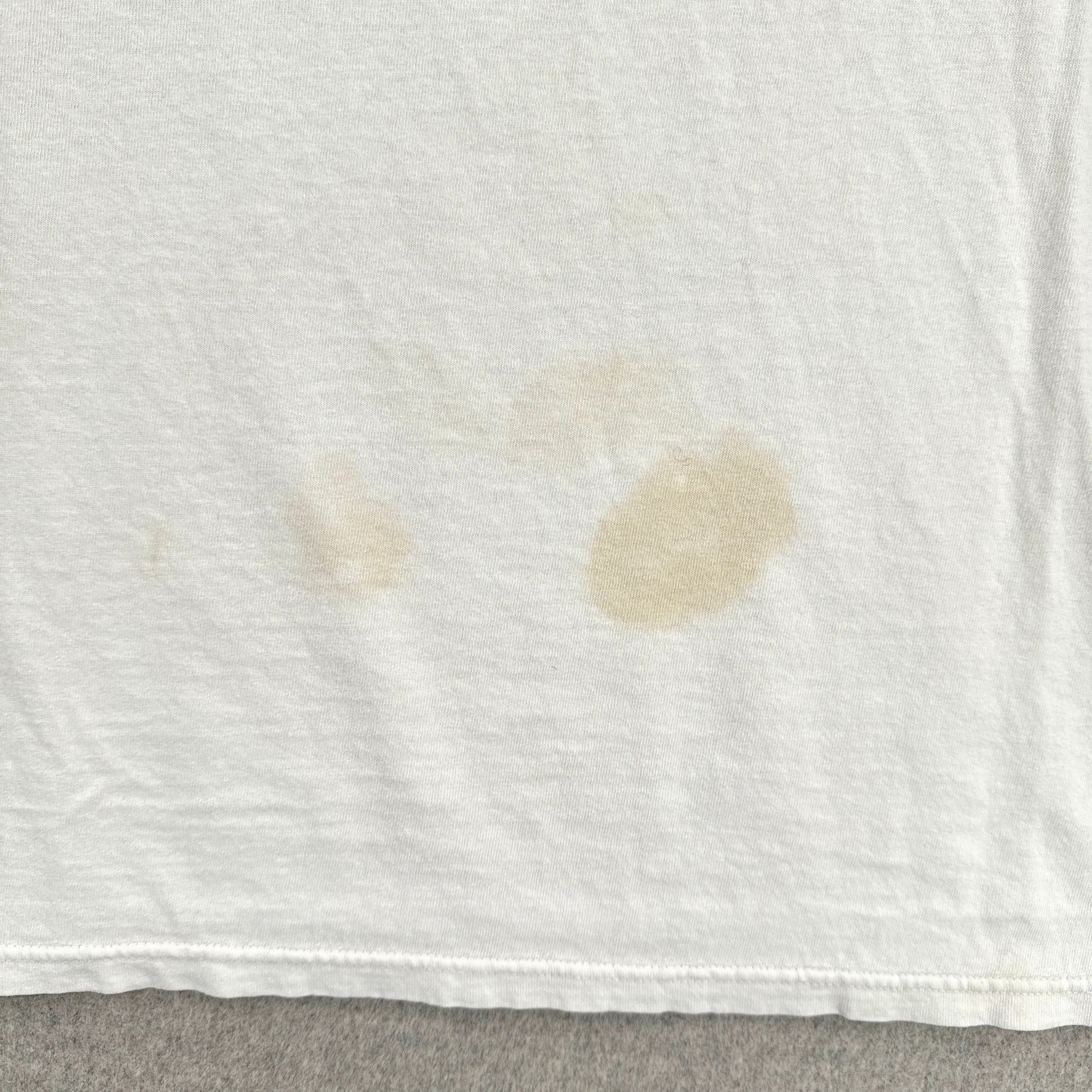 White fabric with brown stains on a gray surface