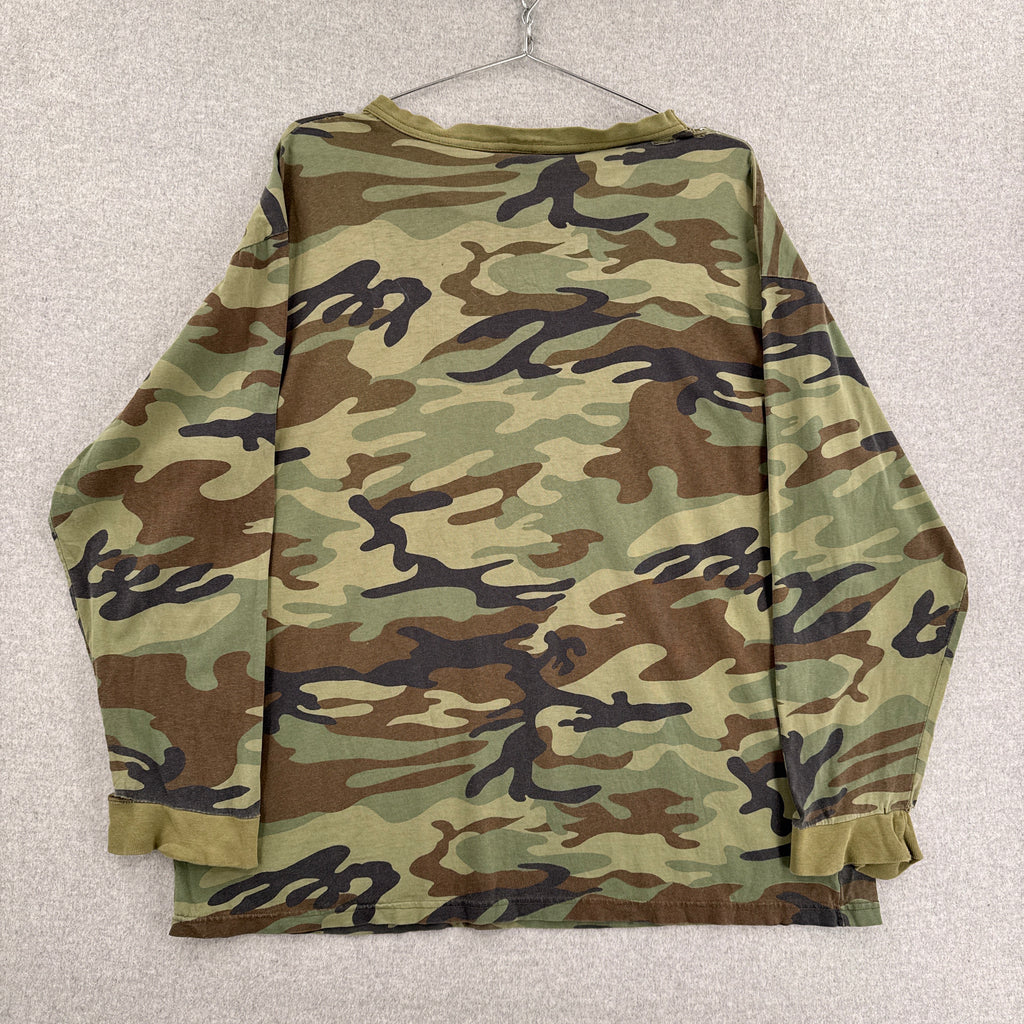 Folded camouflage shirt on a light gray background