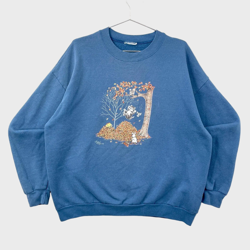 Blue sweatshirt with a graphic design on a gray background