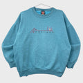 Blue sweatshirt with 'Chicago' skyline design on a textured surface