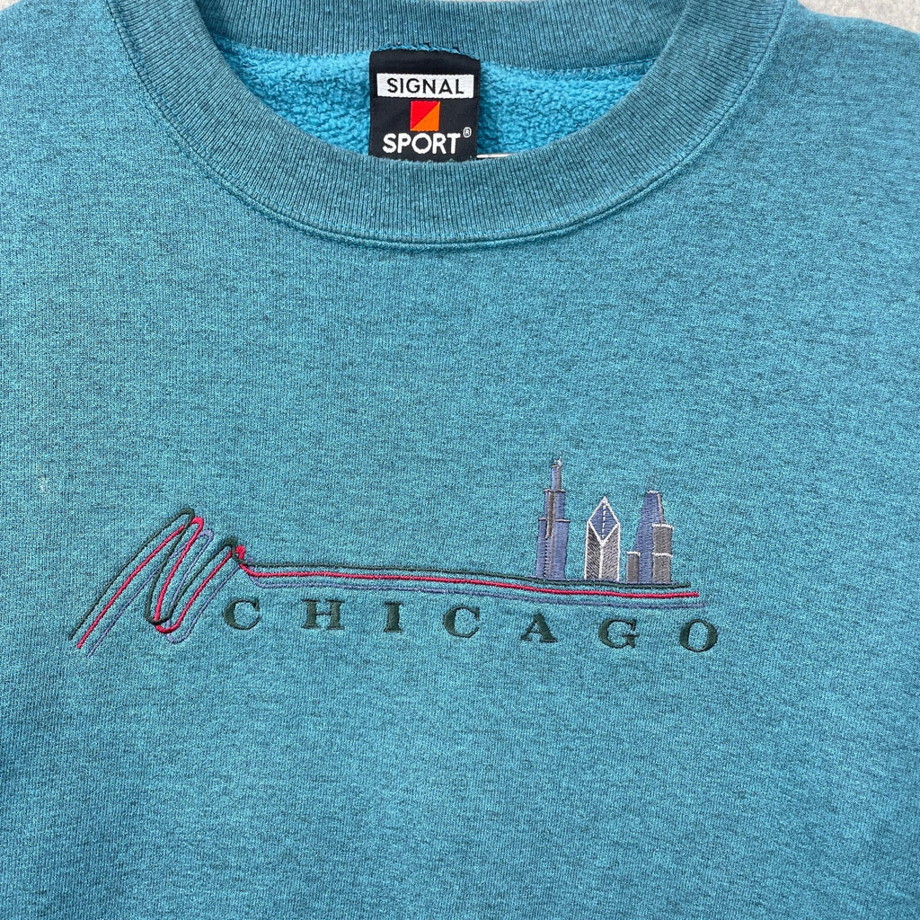 Blue sweatshirt with 'Chicago' skyline design and Signal Sport label.