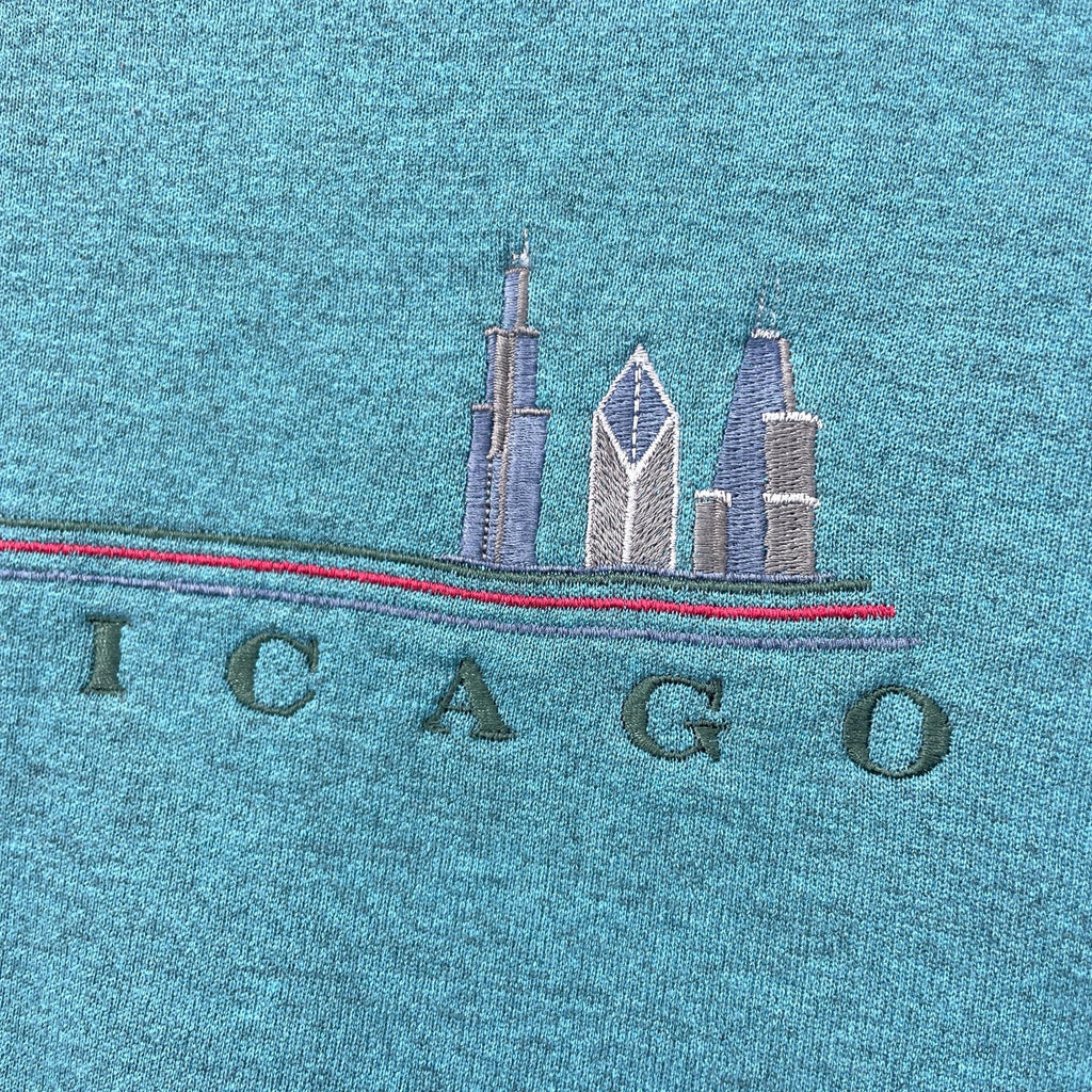 Embroidered Chicago skyline on a blue fabric background