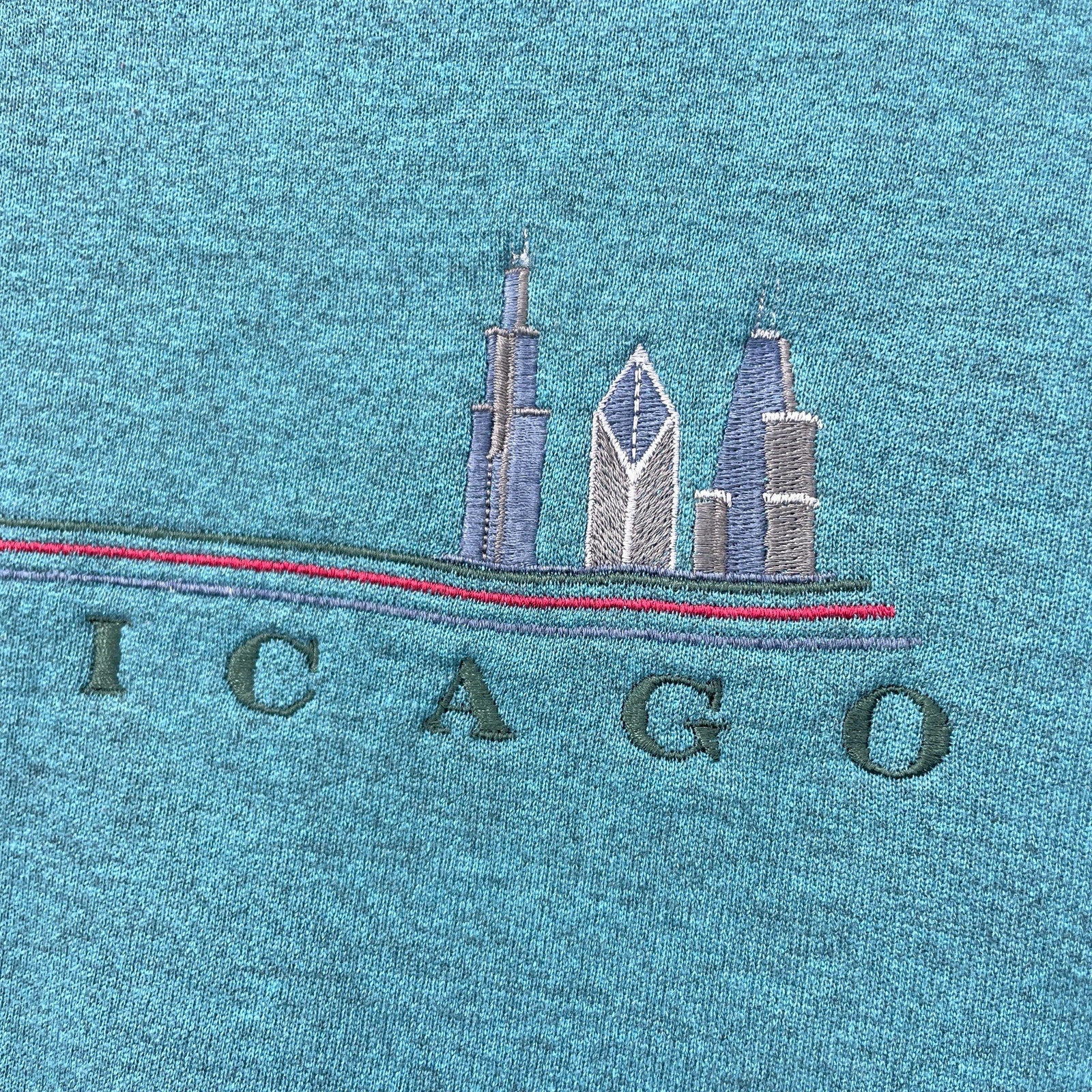 Embroidered Chicago skyline on a blue fabric background
