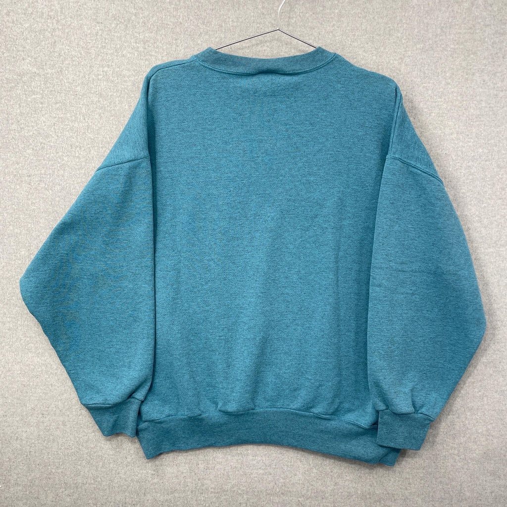 Blue sweatshirt on a hanger against a gray background