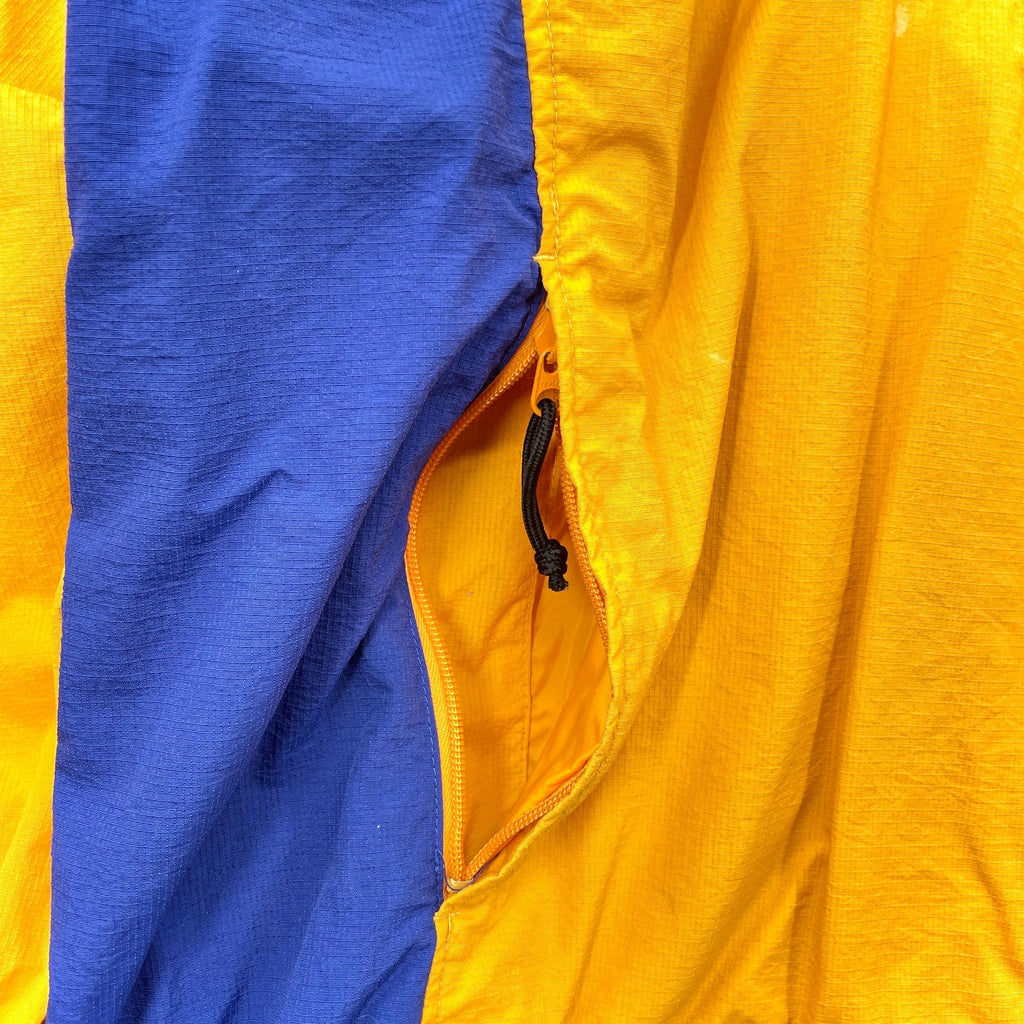 Close-up of a blue and yellow jacket with a zipper.