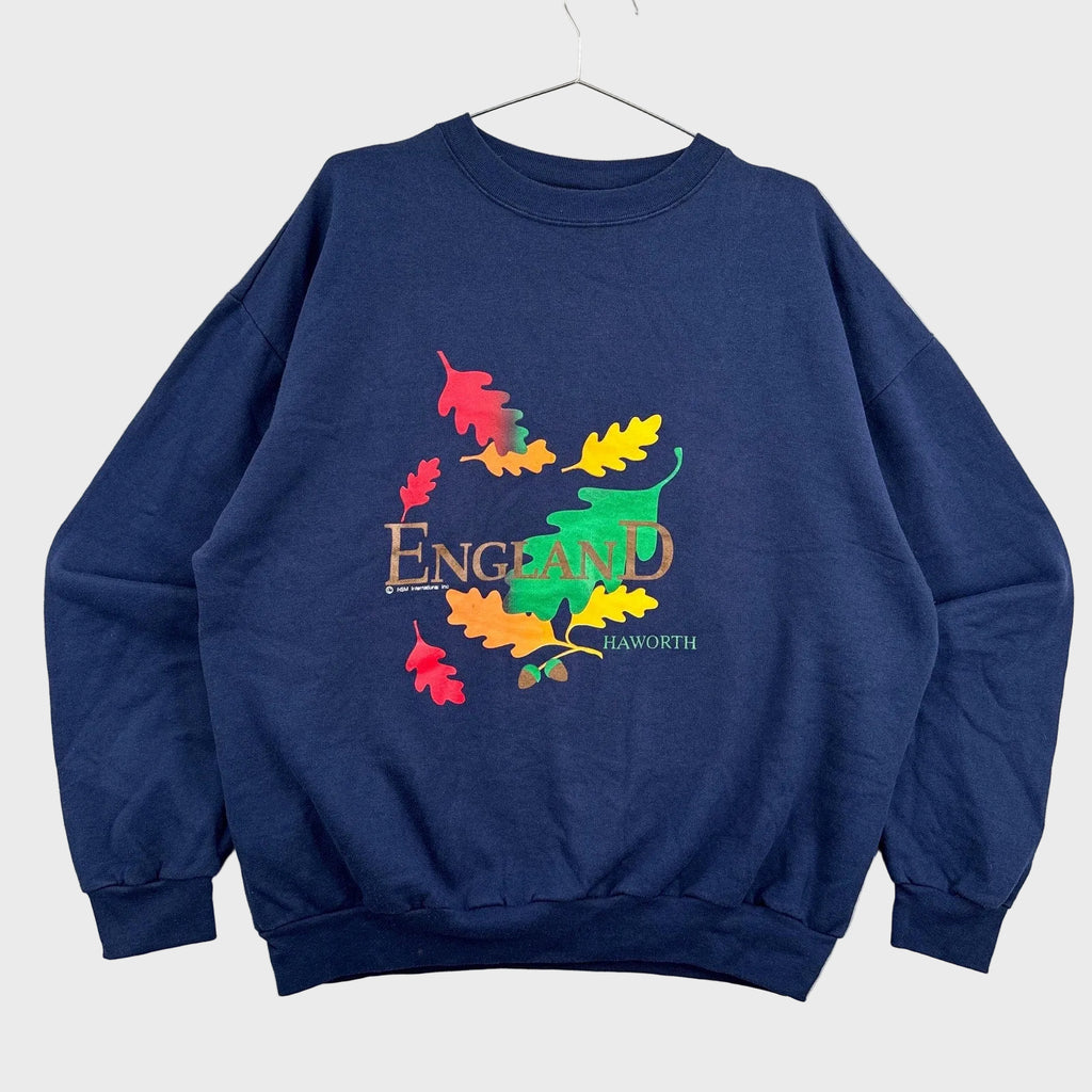 Navy blue sweatshirt with colorful 'England' design on a textured gray background