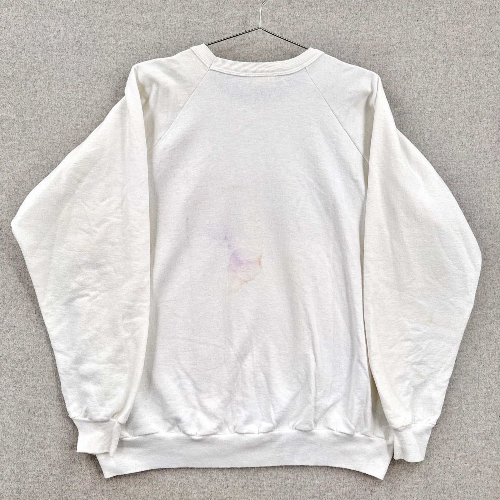 White sweatshirt on a gray background