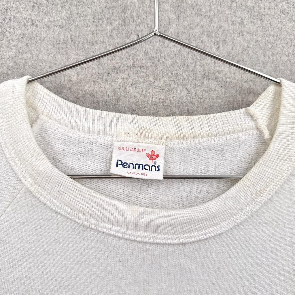 White sweatshirt with a Penmans label on a hanger against a gray background