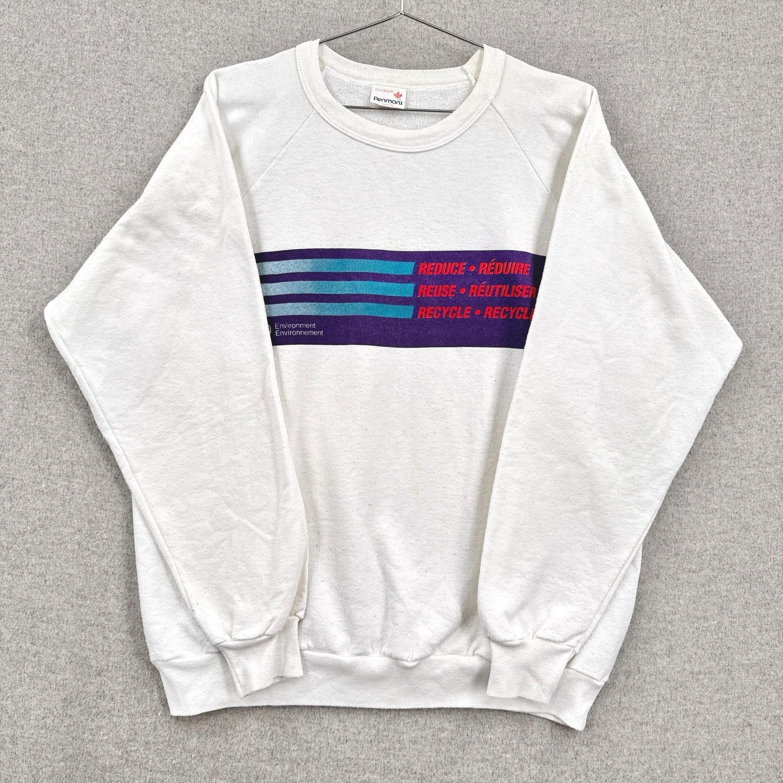 White sweatshirt with colorful stripes on a gray background