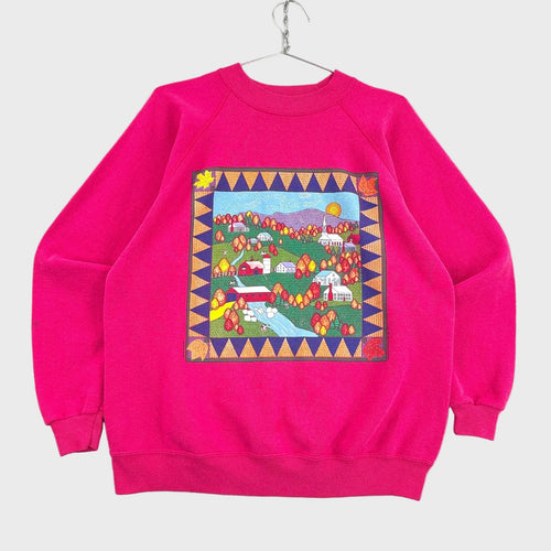 Pink sweatshirt with a colorful patchwork design on a gray background
