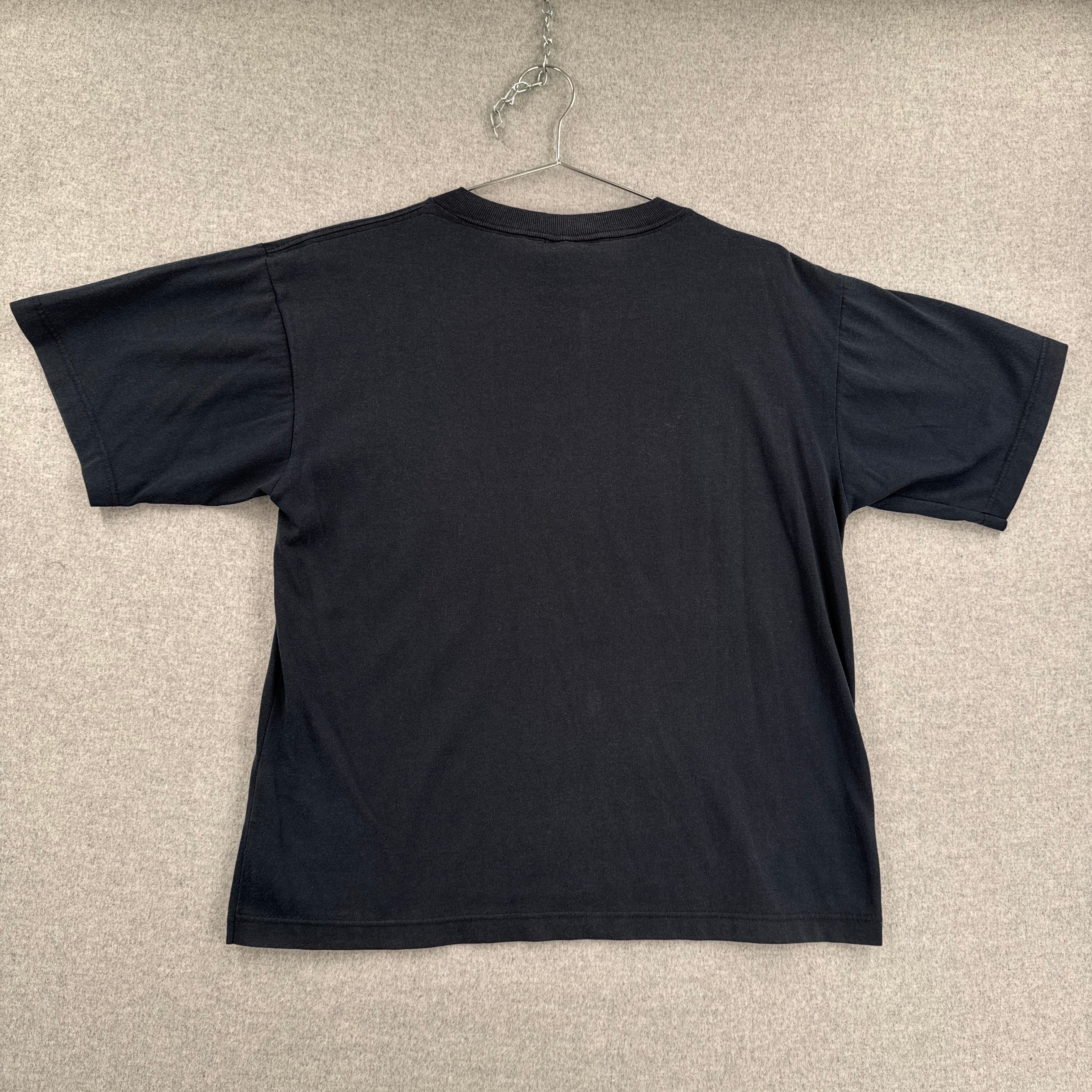 Black tee shirt on a beige textured surface