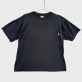 Black t-shirt with a pocket on a beige surface
