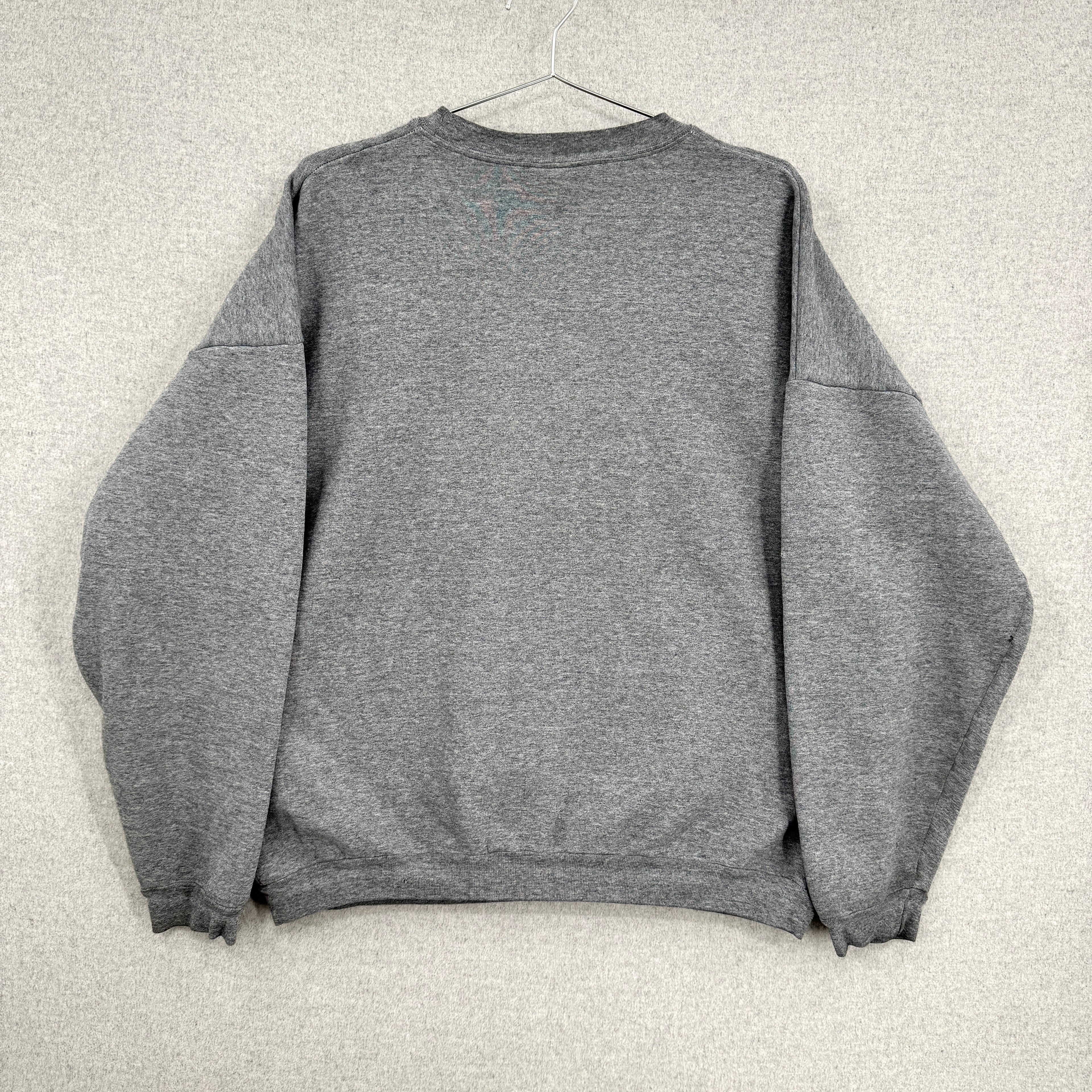 Gray sweatshirt on a hanger against a light gray background, back