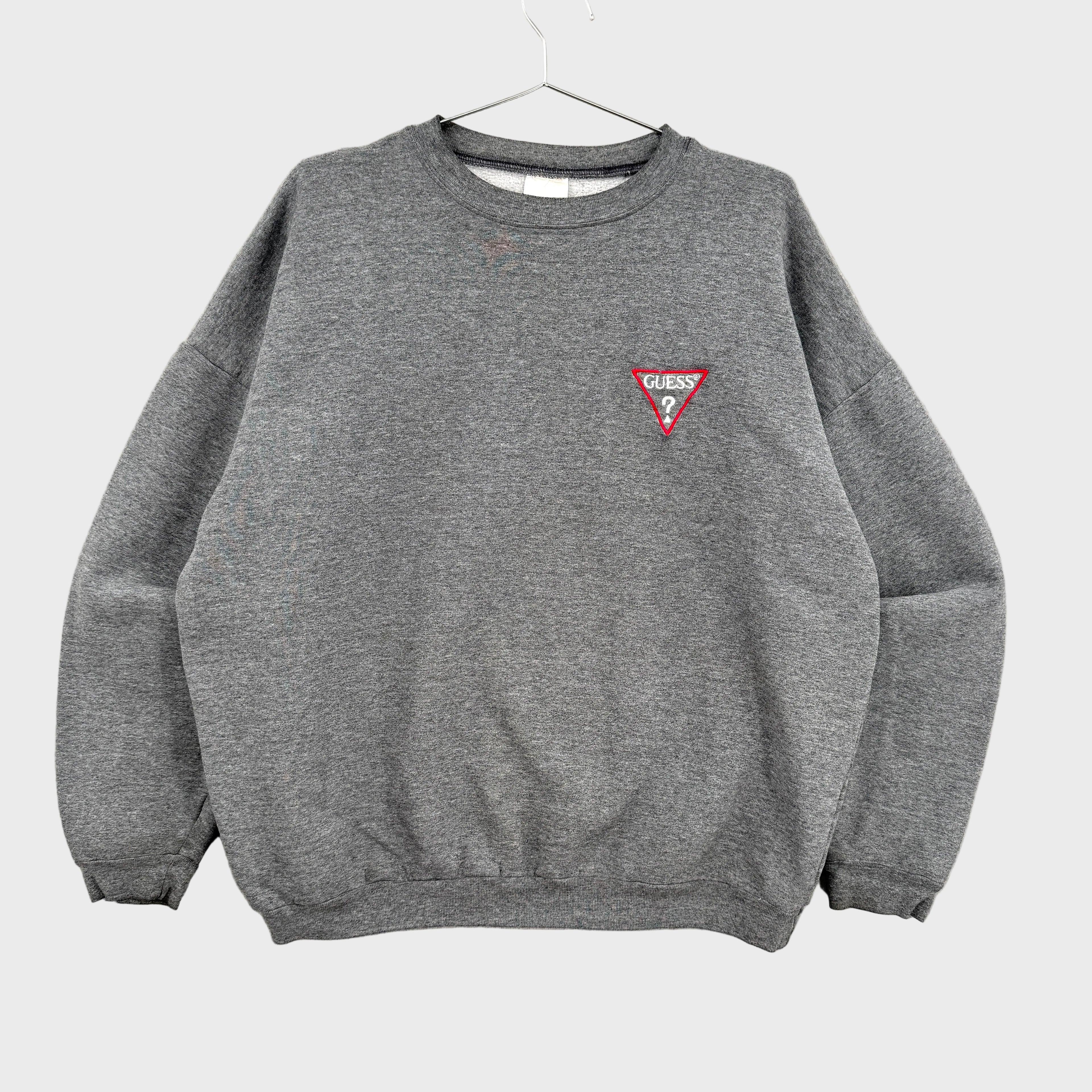 Gray sweatshirt with a red triangle Guess? logo on a gray background