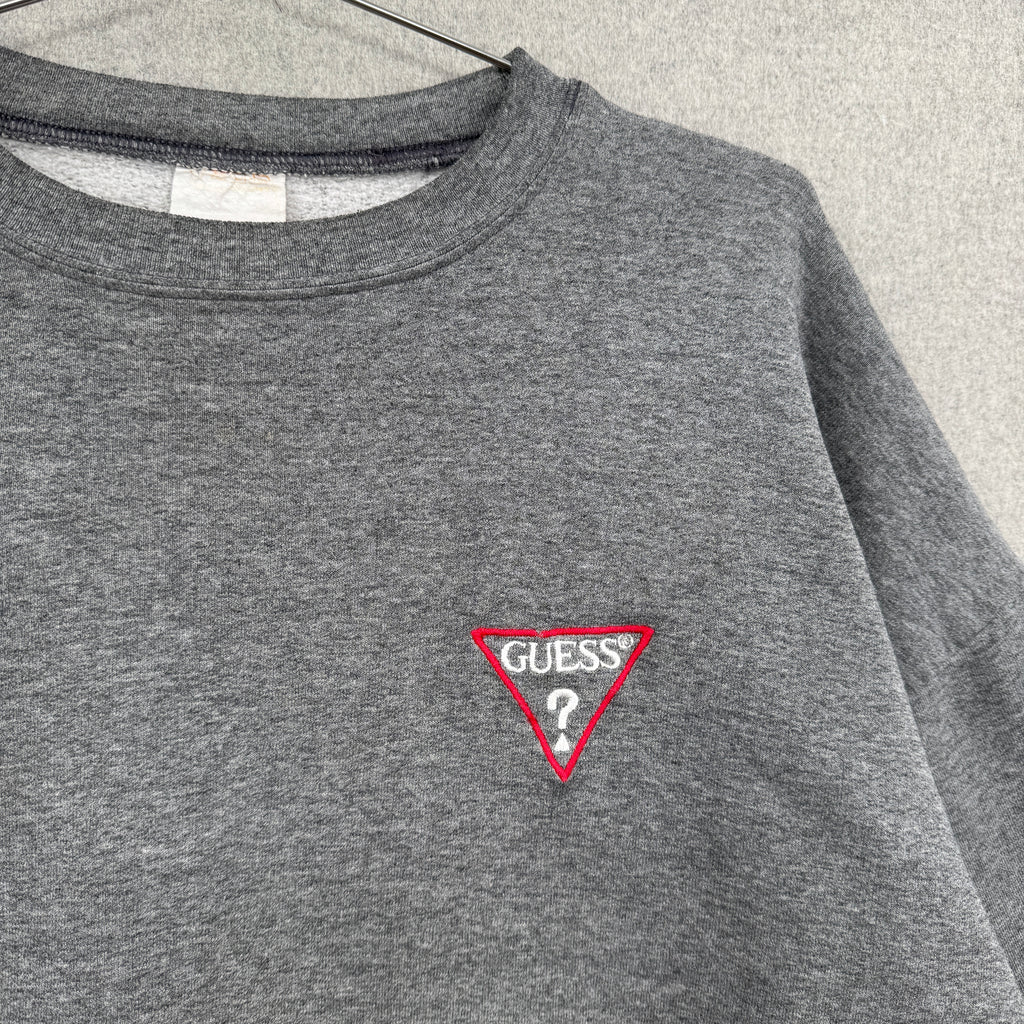 Gray sweatshirt with Guess logo on a light gray background