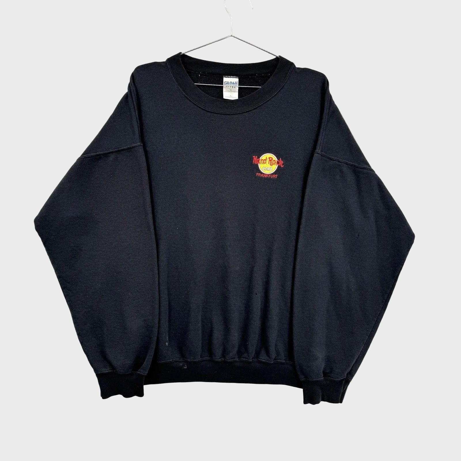 Black sweatshirt with a logo on a gray background