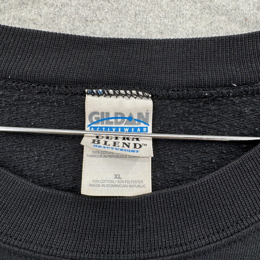 Gildan Activewear label on a black shirt with gray background. size XL