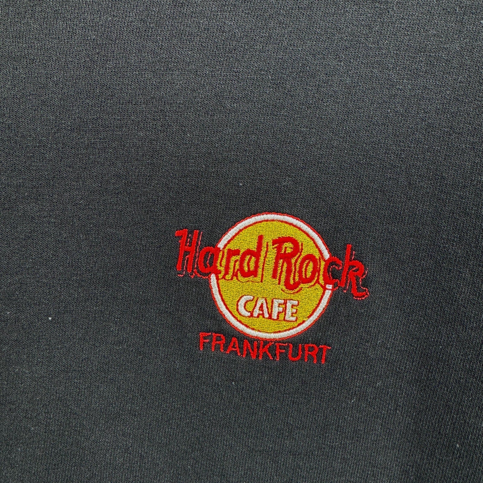 Hard Rock Cafe logo on a dark fabric background
