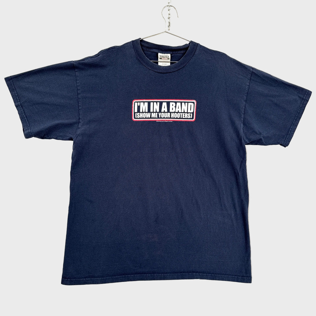 Navy blue t-shirt with text on a beige background