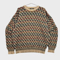 Multicolored patterned sweater on a hanger against a neutral background