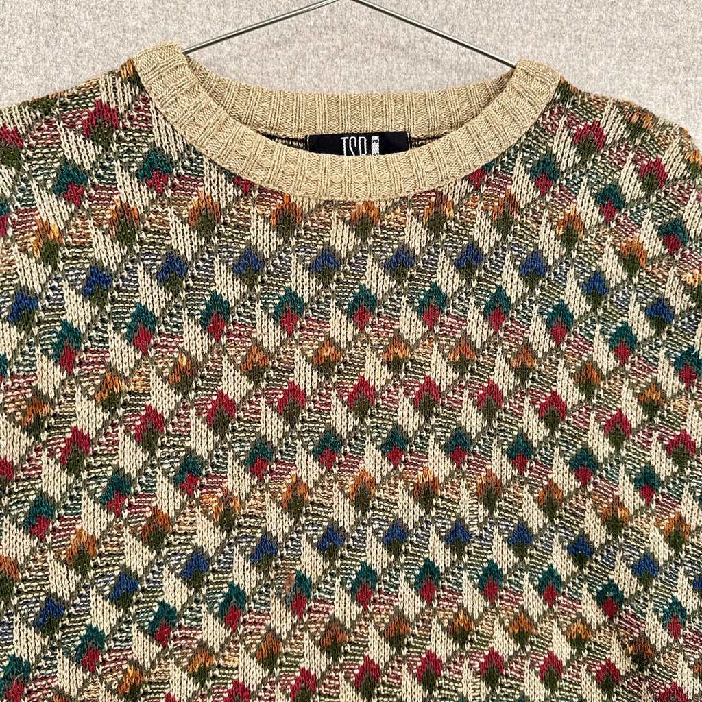 Patterned sweater with a visible brand label on a neutral background