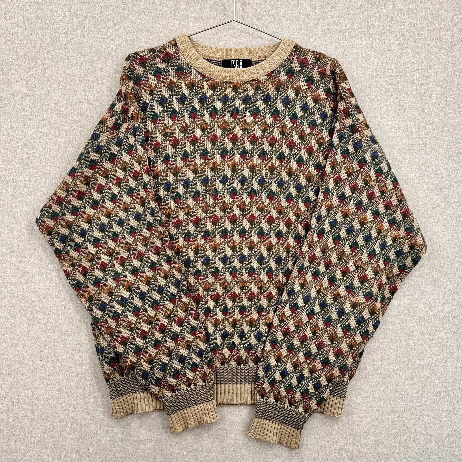 Multicolored patterned sweater on a textured surface