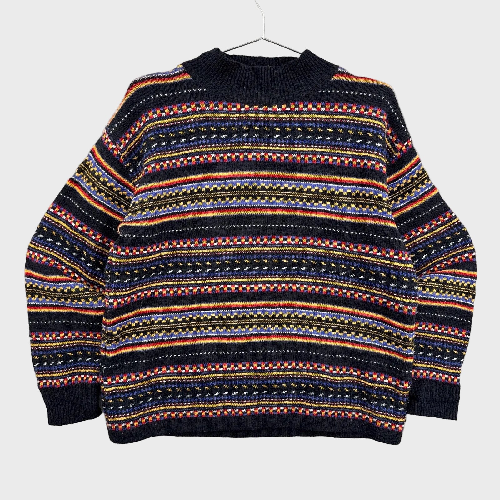 Multicolored patterned sweater on a gray background