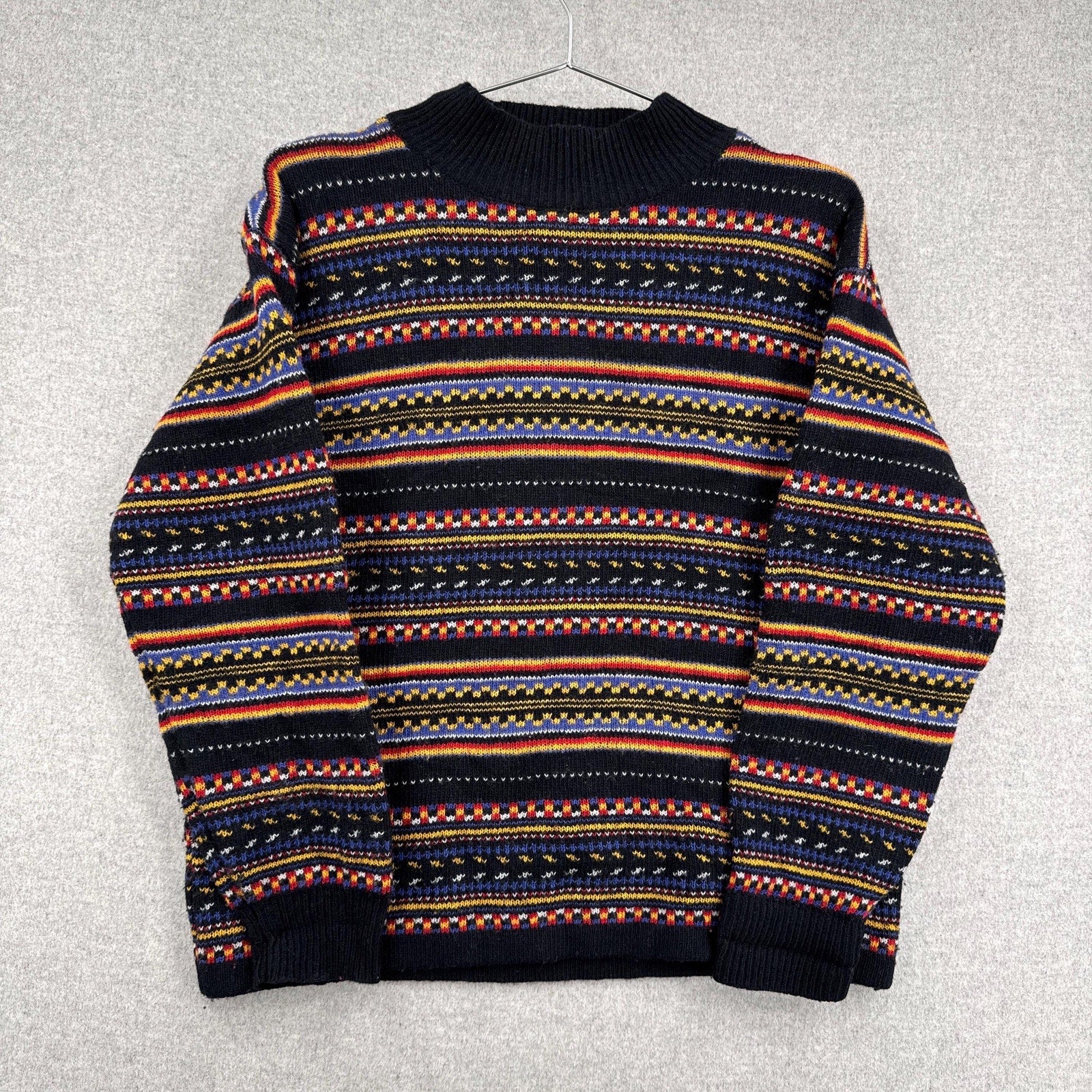 Multicolored patterned sweater on a gray background