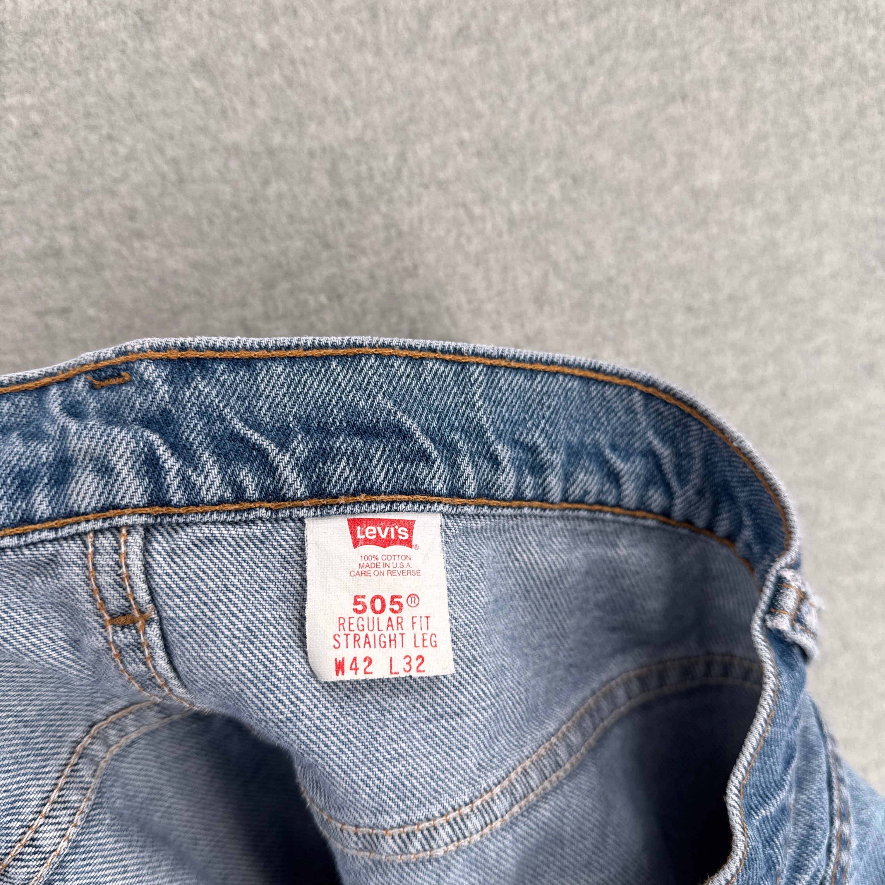 Levi's jeans label on a gray background. 505 regular fit straight leg