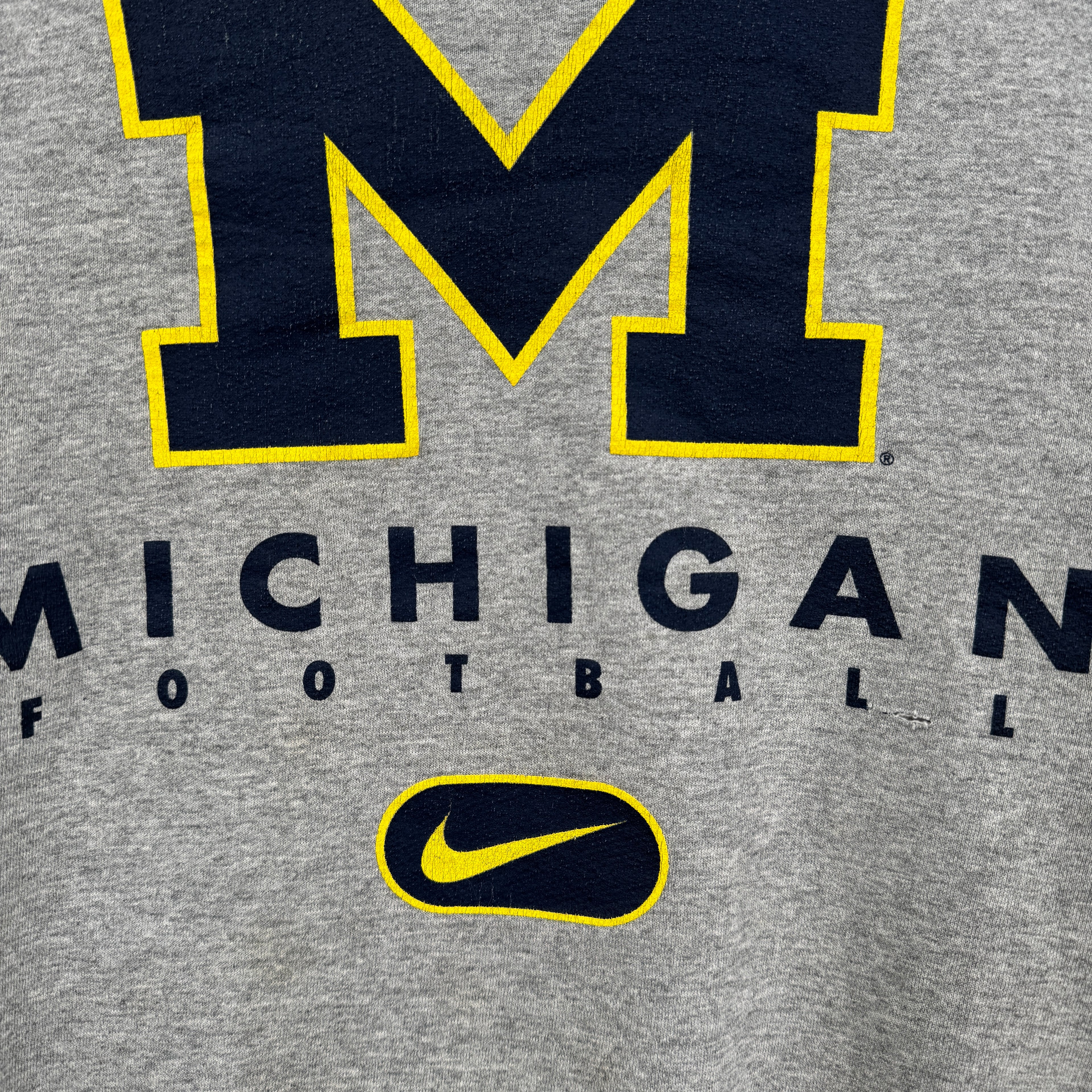 Gray sweatshirt with Michigan football text and Nike logo