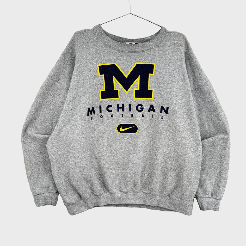 Gray sweatshirt with Michigan football logo on a gray background, Nike swoosh