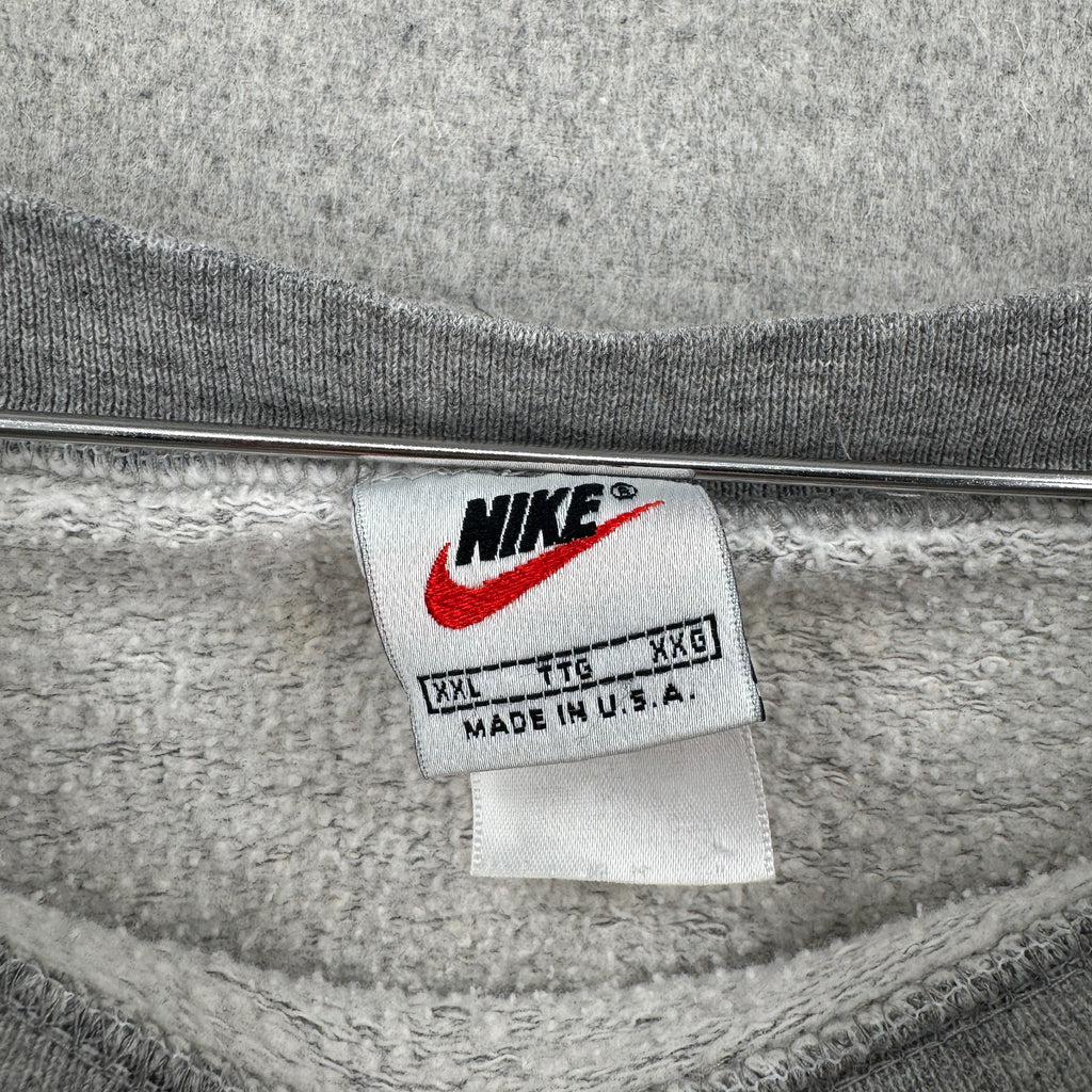 Gray sweatshirt with a Nike label on a gray background. made in USA size 2XL