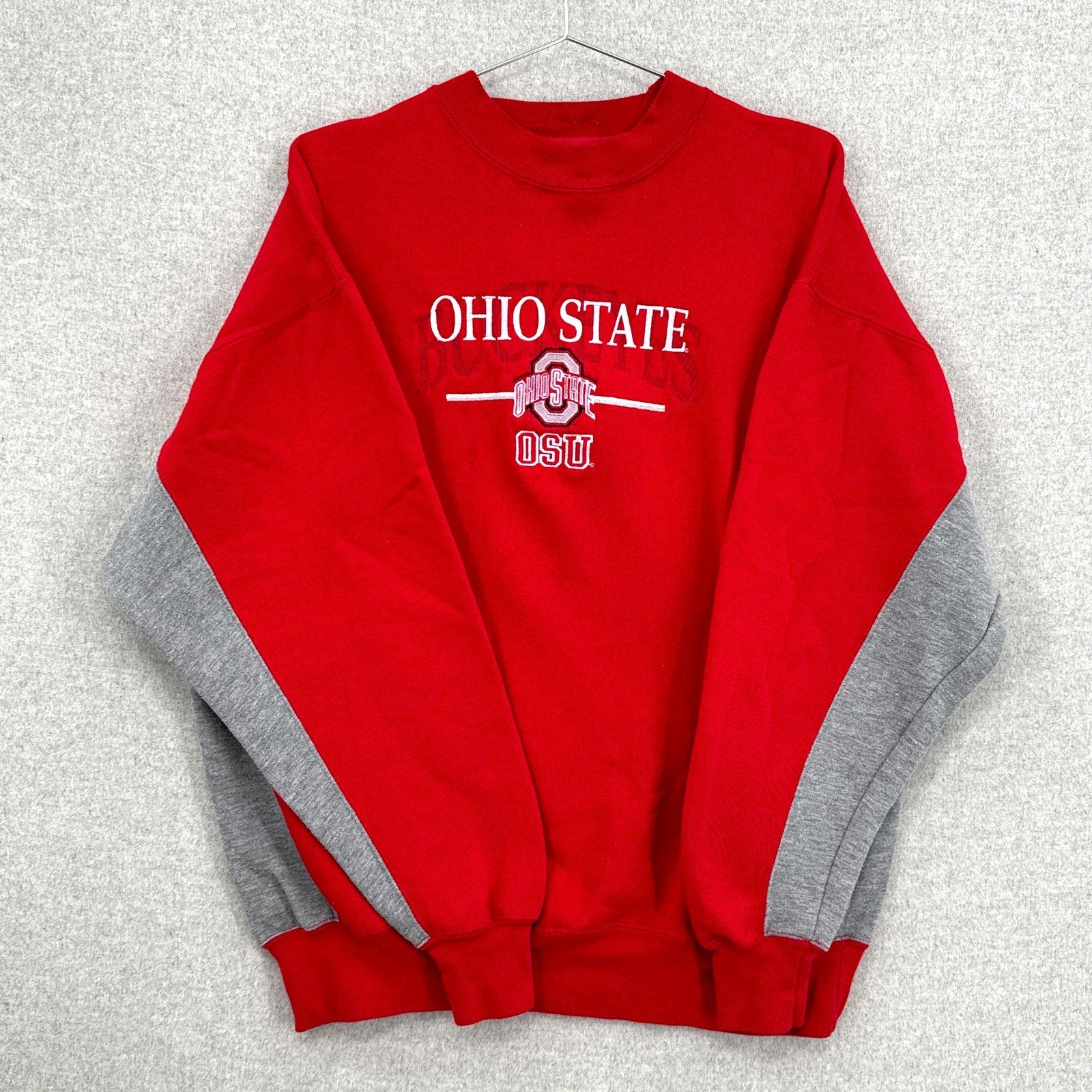 Red Ohio State sweatshirt with gray sleeves on a light gray background
