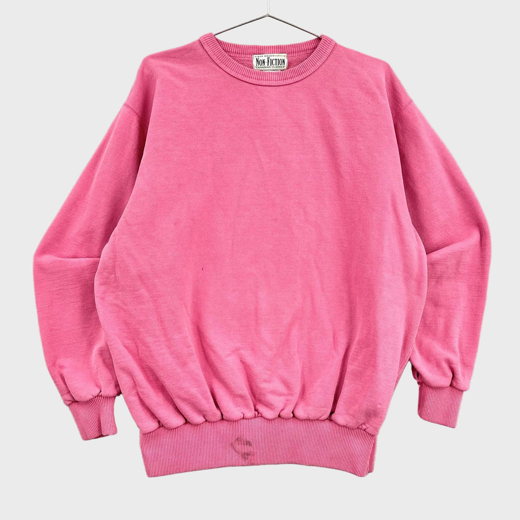 Pink blank sweatshirt on a hanger with a neutral background