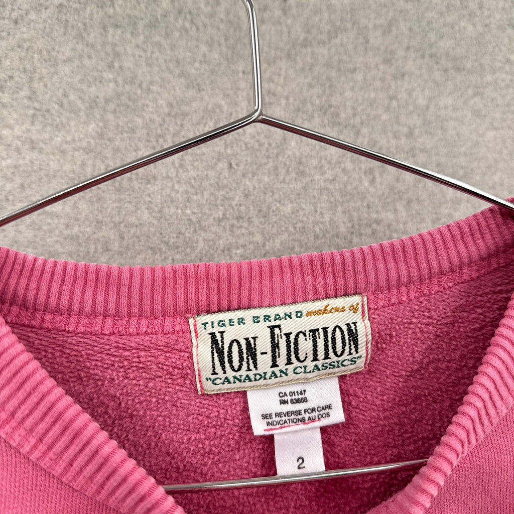 Pink garment with 'Non-Fiction' label on a hanger