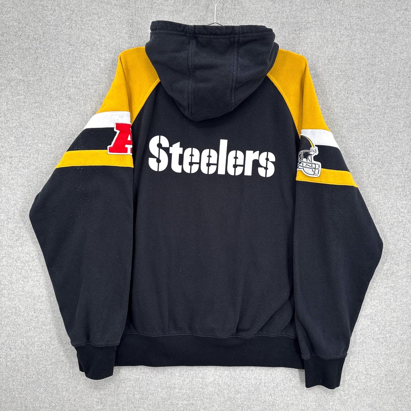 Black hoodie with 'Steelers' text and logo on a gray background