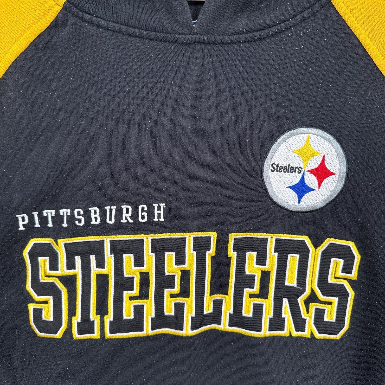 Navy blue and yellow sports jersey with Pittsburgh Steelers logo and text
