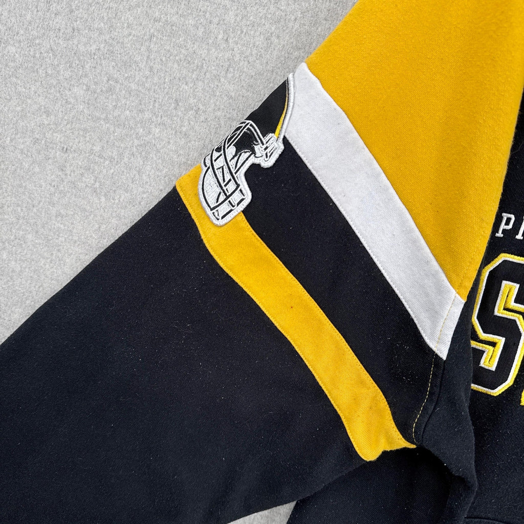 Close-up of a sports hoodie with black, yellow, and white colors on a gray background