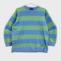 Blue and green striped sweater on a beige background