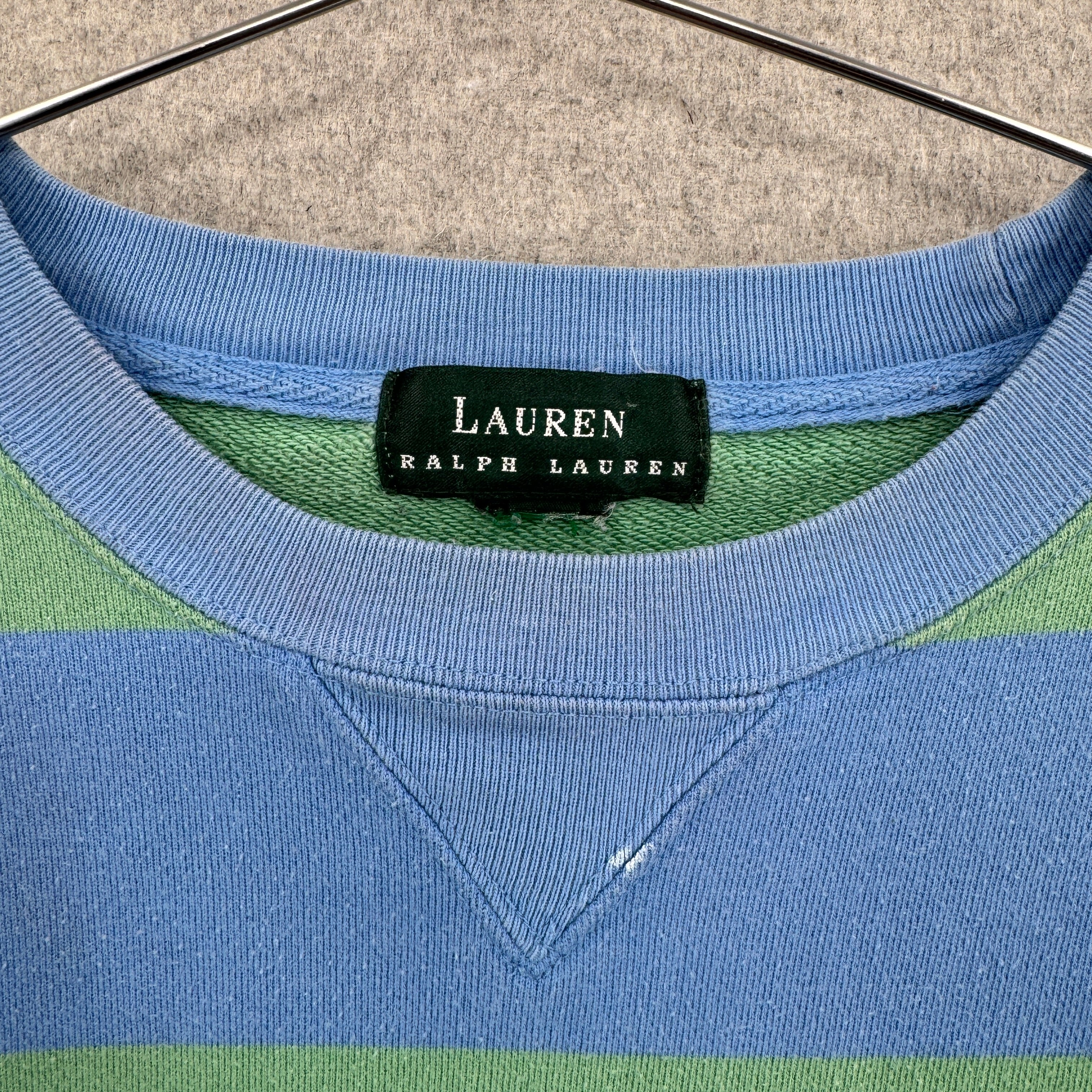 Close-up of a Lauren Ralph Lauren label on a blue and green striped shirt.