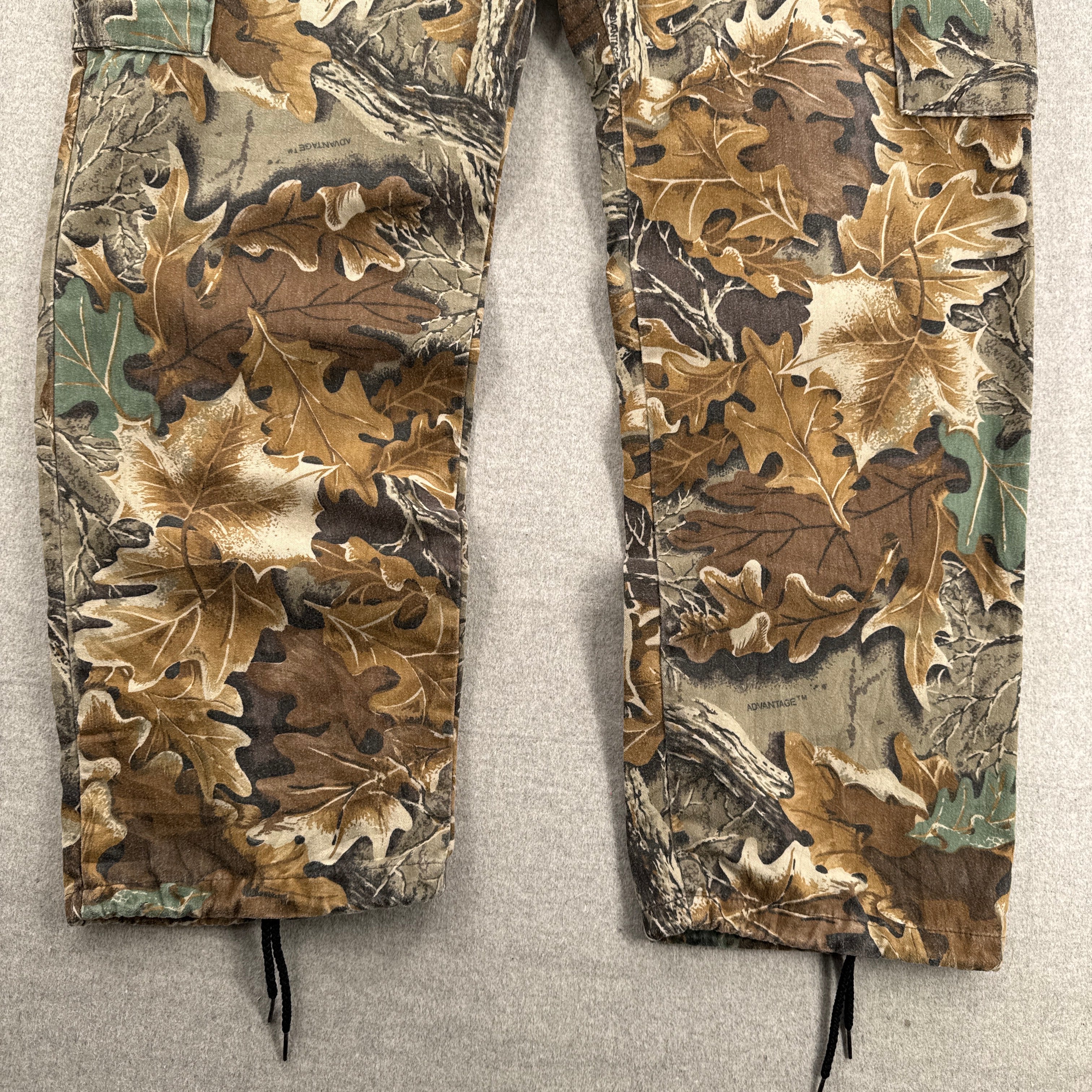 Two camouflage-patterned pants on a light gray background